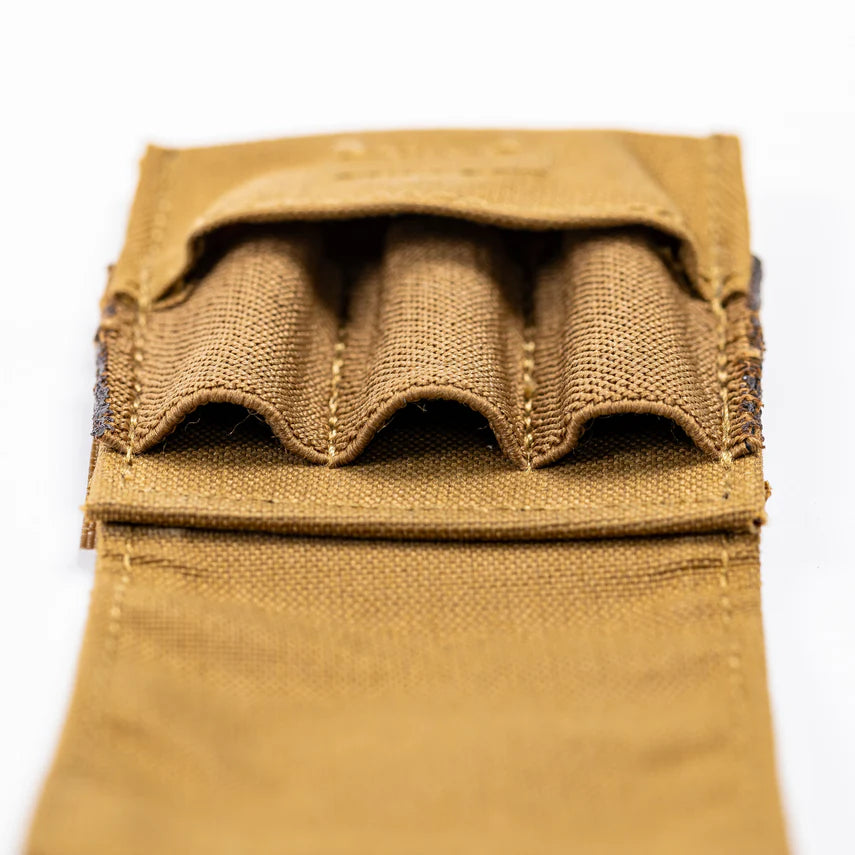 Close-up of a brown bullet holder on a white background