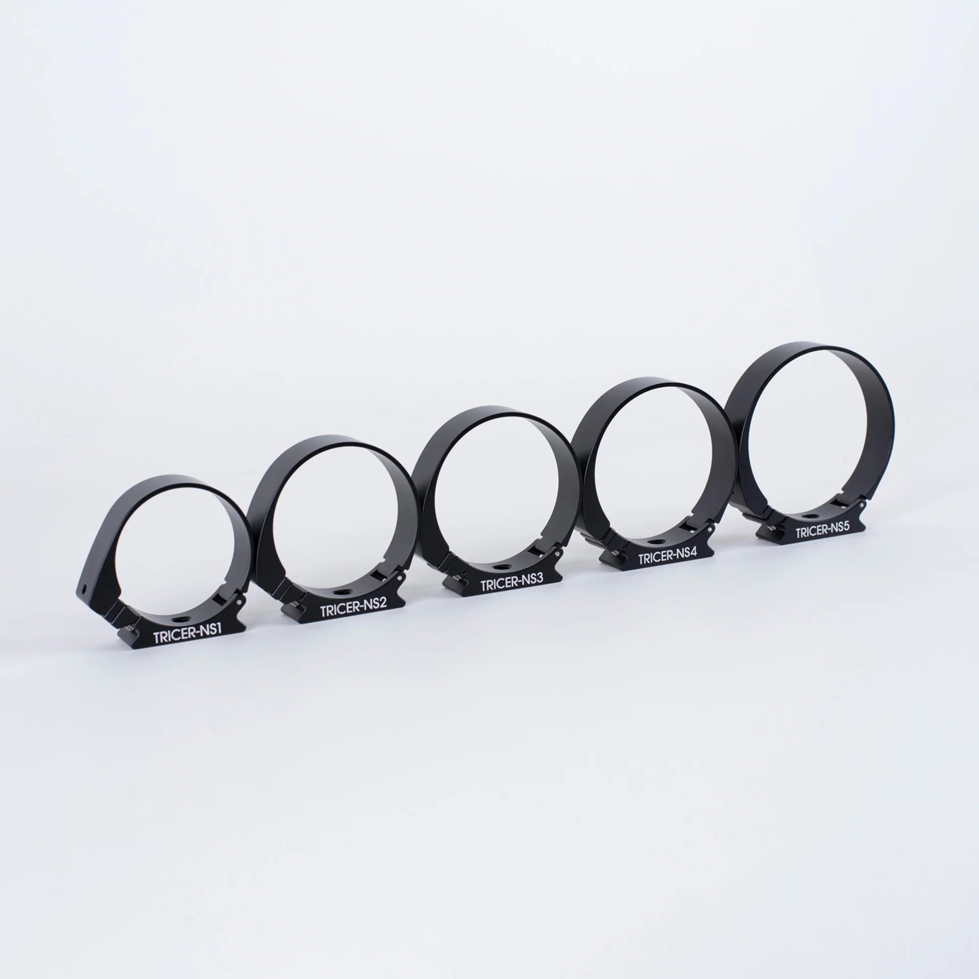 Set of six black Arca-Swiss adapters with 'TRICER' branding on a white background